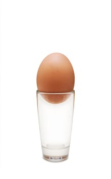 Chicken egg and glass isolated on white background