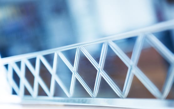 Glass, mirror reflection shapes and shadows. Close-up details.  Abstract geometric design with parallel and intersecting lines. Graphical representation of angle