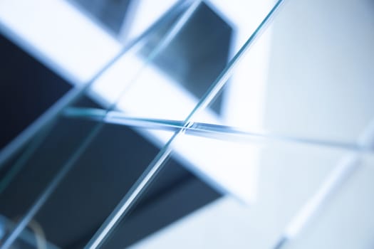 Glass, mirror reflection shapes and shadows. Close-up details.  Abstract geometric design with parallel and intersecting lines. Graphical representation of angle