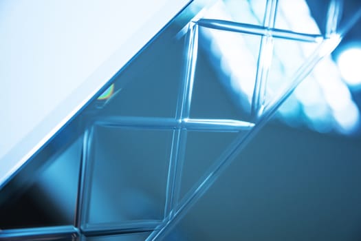 Glass, mirror reflection shapes and shadows. Close-up details.  Abstract geometric design with parallel and intersecting lines. Graphical representation of angle