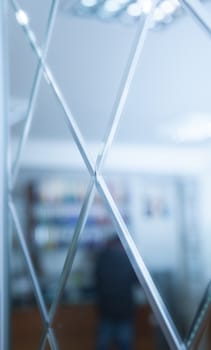 Glass, mirror reflection shapes and shadows. Close-up details.  Abstract geometric design with parallel and intersecting lines. Graphical representation of angle