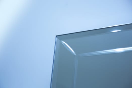 Glass, mirror reflection shapes and shadows. Close-up details.  Abstract geometric design with parallel and intersecting lines. Graphical representation of angle