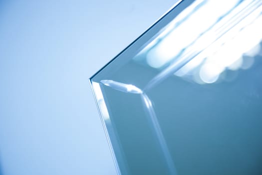 Glass, mirror reflection shapes and shadows. Close-up details.  Abstract geometric design with parallel and intersecting lines. Graphical representation of angle