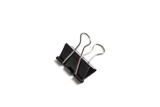 Paper clip isolated from white background. A paperclip is a device for office use to clamp a device such as paper and more.