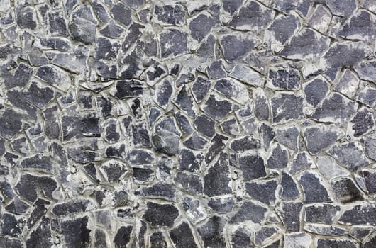 Antique natural stonewall, old stones in different sizes