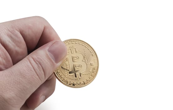 man's hand holding golden Bitcoin on a white background