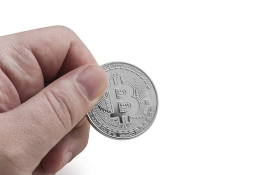 man's hand holding silver Bitcoin on a white background