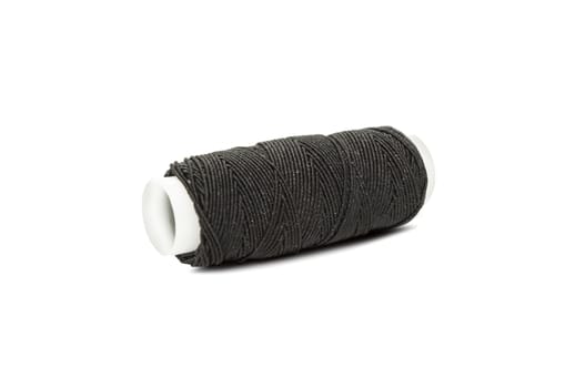 Black elastic thread on the coil horizontally isolated on white background