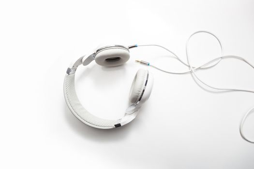 White headphones and Convention Aux cable 3.5 mm. Isolated on white background