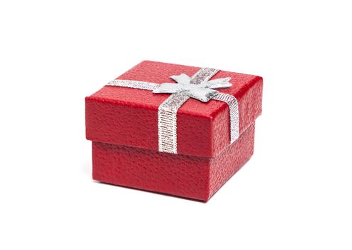 Red gift box with silver ribbon isolated on white background