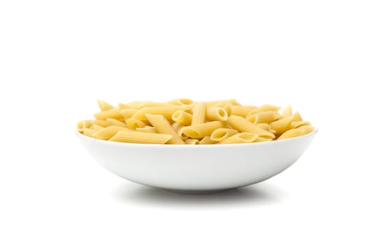 Pasta penne macaroni in bowl over isolated on a white background. Products from flour.