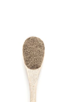 Ground black Pepper spices in wooden spoon isolated on white background