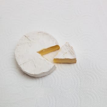 Fresh slice Camembert cheese natural, on white paper background. With clipping path