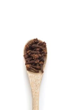 Cloves spices in wooden spoon isolated on white background