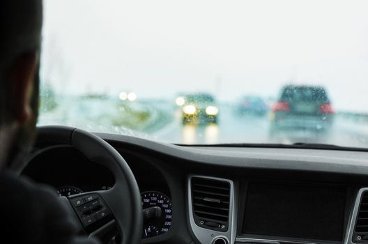 Driving in snowfall. Inside view of the car