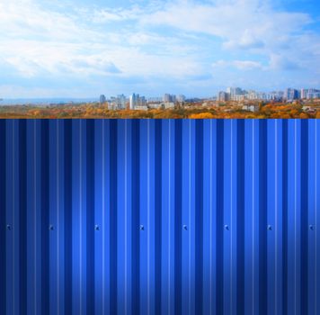 Fence made of metal panels a blue color outdoors