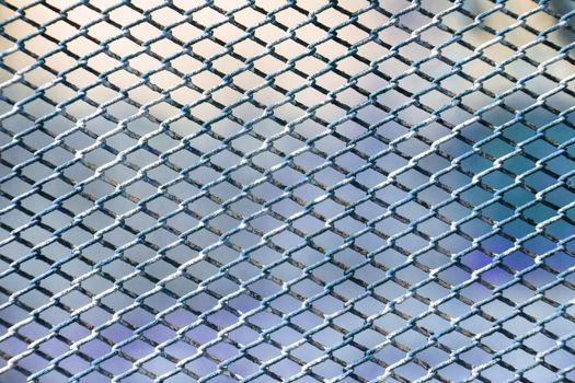 Rusty fence of color metal mesh background