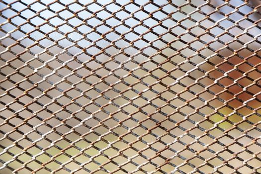 Rusty fence of color metal mesh background