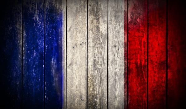 Flag of France painted on grungy wooden plank background