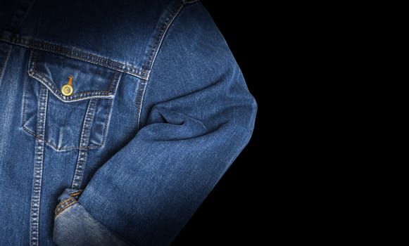 Jeans jacket blue color, isolated on black background. Top view
