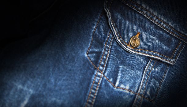 CHISINAU, MOLDOVA - December 25, 2017: Jeans jacket Wrangler blue color. Pocket closeup. The Wrangler brand is owned by VF Corporation of Greensboro, North Carolina USA. Blurred concept