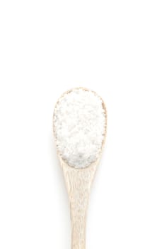 Salt spice in wooden spoon isolated on white background