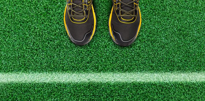 White stripes and man shoe on the grass floor. Line on soccer field.