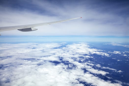 Wing of an airplane and the land below