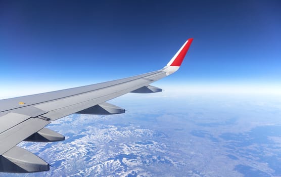 Wing of an airplane and the land below