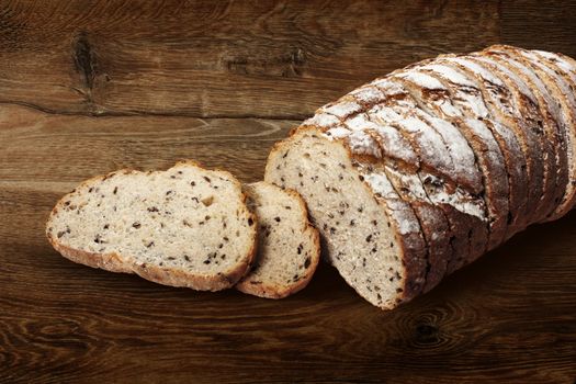 Sliced rye bread with linseed on wooden background. With clipping path