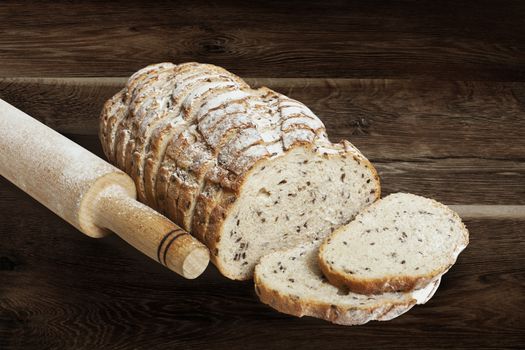 Sliced rye bread with linseed on wooden background. With clipping path
