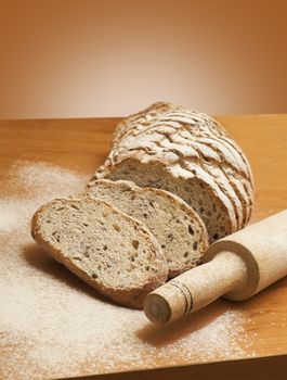 Sliced rye bread with linseed on wooden background.