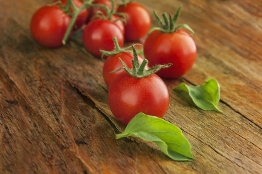 Cherry tomatoes on a wooden surface with natural light