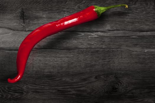 Red chili pepper isolated on wooden background. With clipping path