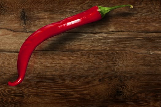 Red chili pepper isolated on wooden background. With clipping path