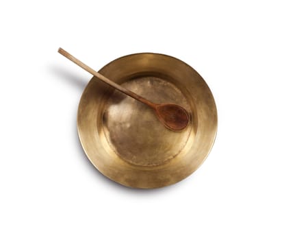 Empty copper tray, wooden spoon on a wooden table. With clipping path