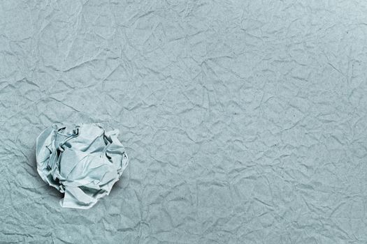 Crumpled paper ball on crumpled paper, for backgrounds or textures