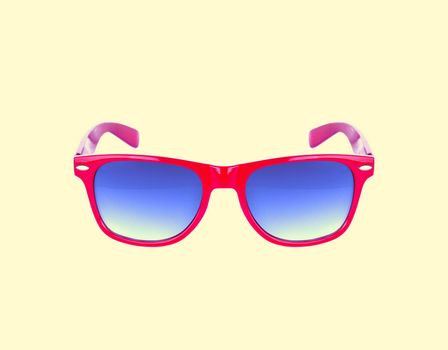 Red sun glasses isolated over the yellow background