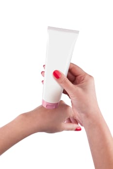 Hand holding cream tube isolated on white background. With clipping path