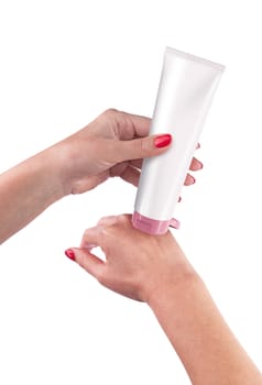 Hand holding cream tube isolated on white background. With clipping path