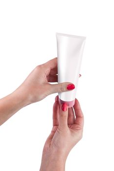 Hand holding cream tube isolated on white background. With clipping path