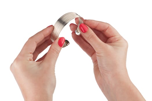 Female hands with red manicure holding a bracelet, isolated on white background. With clipping path
