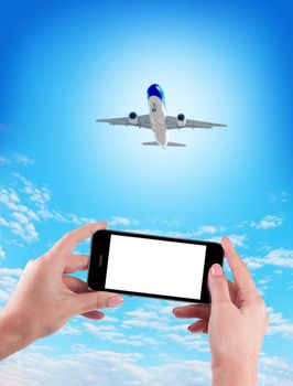 Female Hand holding using mobile phone and airplane on a blue background