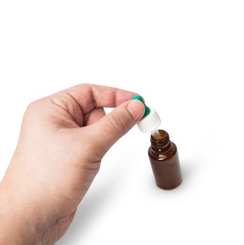 Hand man scientist, doctor keeps the pipette for drop over the container with liquid, medication or chemical substance laboratory. Isolated on white background with clipping path