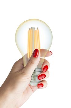 LED filament light bulb in female hand. Isolated on white background.