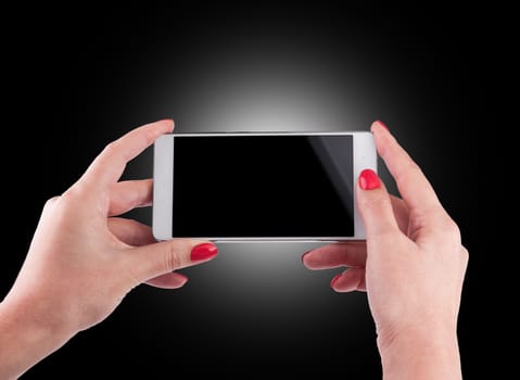 Female Hand holding and Touching a Smartphone isolated on black background.