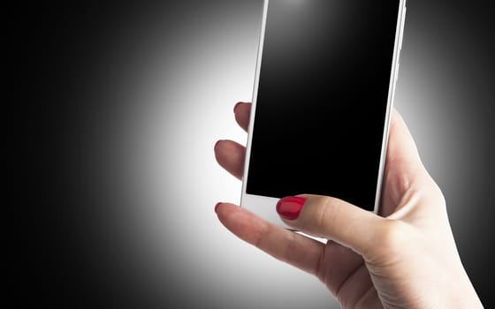Female Hand holding and Touching a Smartphone isolated on black background