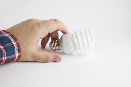 Energy saving lamp in the man's hand on white background closeup