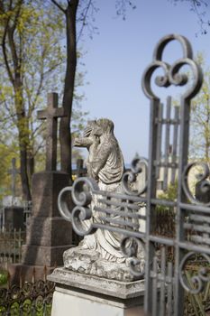 Angel and cross monument on a very old grave.