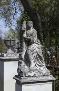 Angel and cross monument on a very old grave.